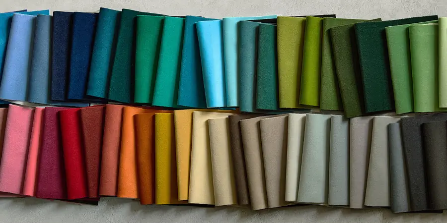 Gevouwen velours in alle kleuren op een rij. Stoffen van Harlequin.